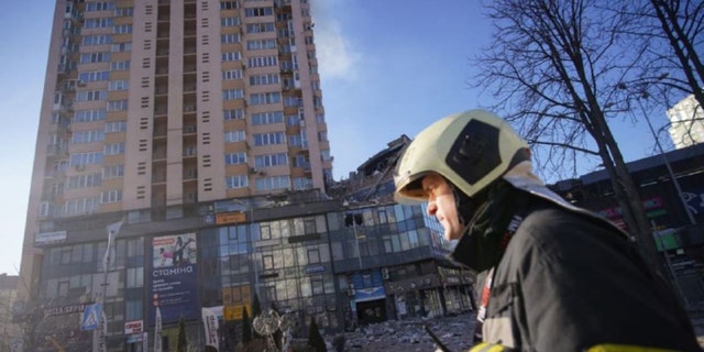 The rubble can be seen beneath a high-rise apartment building that the government says was hit by a missile during the night. 