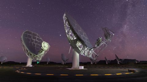 MeerKAT radio telescope dishes can be seen under the starry sky in Karoo, South Africa. 