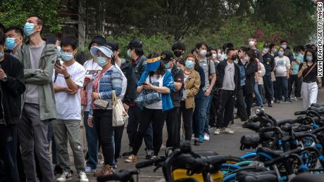 People line up for Covid tests at a temporary testing site in Beijing's Chaoyang District on Monday.