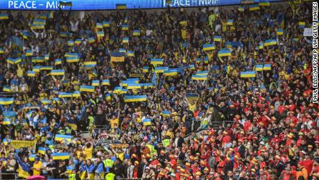 Ukraine fans raise their country's flag at Cardiff City Stadium. 