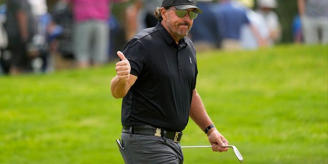 Phil Mickelson responds to the crowd on the eighth hole during the first round of the US Open golf tournament at The Country Club, Thursday, June 16, 2022, in Brooklyn, Massachusetts. 