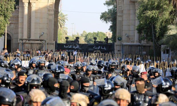 Iraqi security forces stand guard as protesters attempt to storm the Green Zone.
