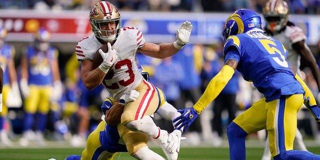 San Francisco 49ers running back Christian McCaffrey, left, stiff arms of the Los Angeles Rams, Galen Ramsey, during the first half on Oct. 30, 2022, in Englewood, California.