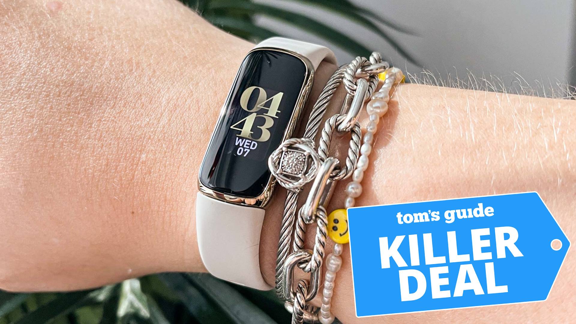Image of a person wearing a Fitbit Luxe watch on their wrist.  The "Fatal deal from Tom's Guide" The tag is overlaid.